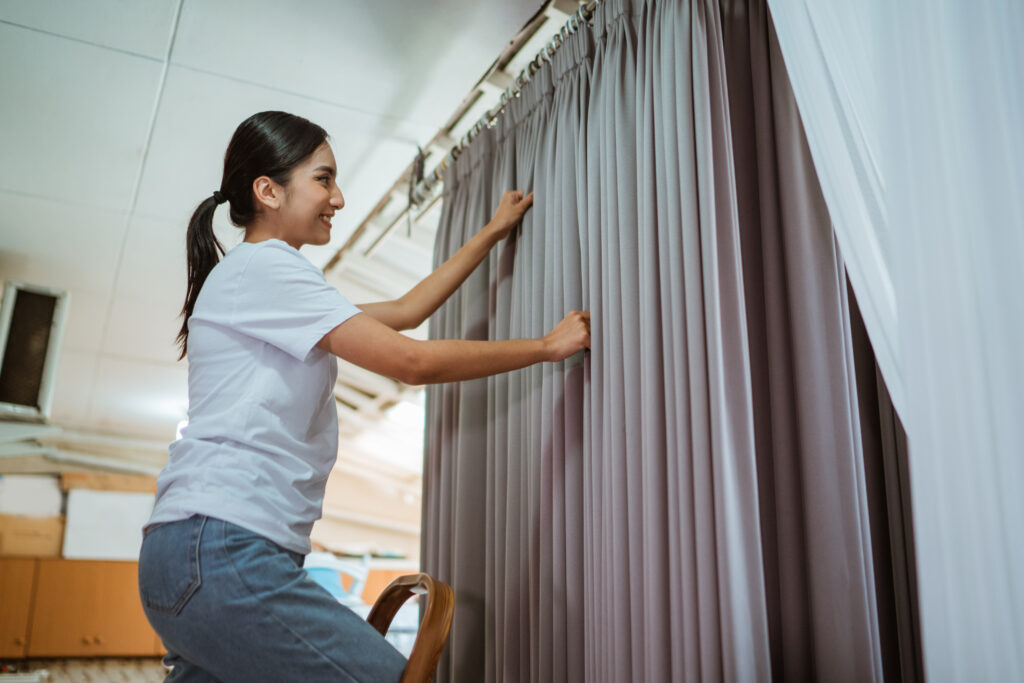 beautiful asian production crew putting he curtain hanger beautiful asian production crew putting he curtain hanger