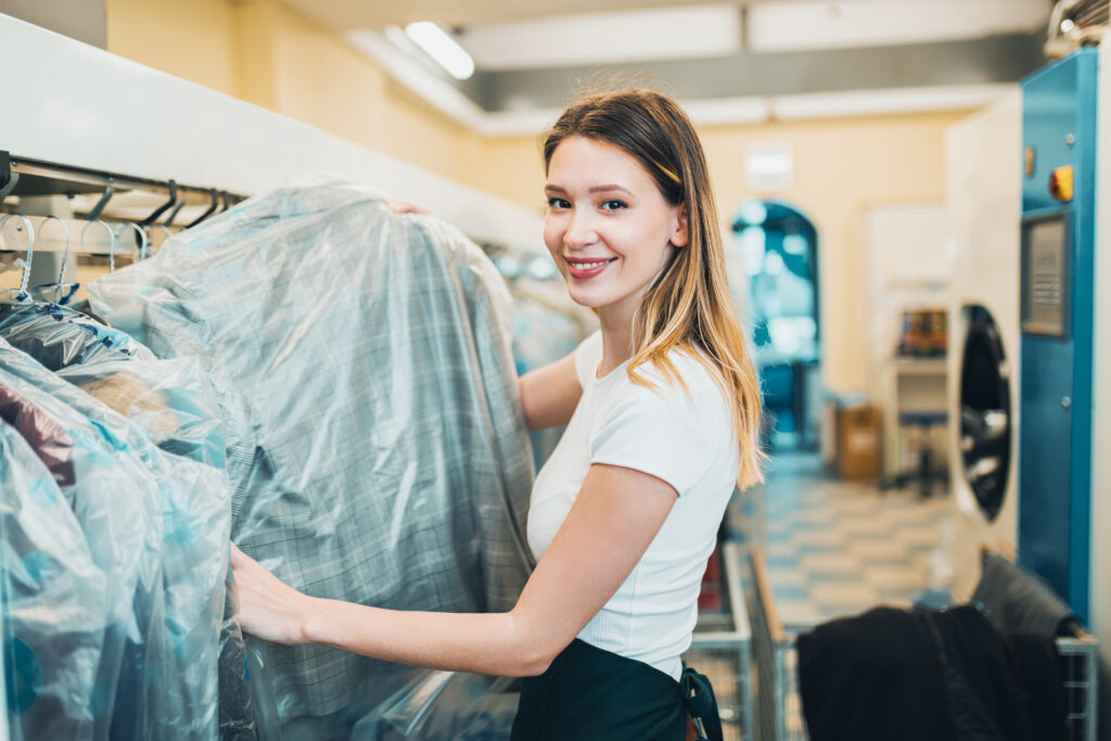 young female worker dry cleaning salon young female worker dry cleaning salon